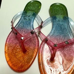 A rainbow color palette and sparkly rhinestone embellishment